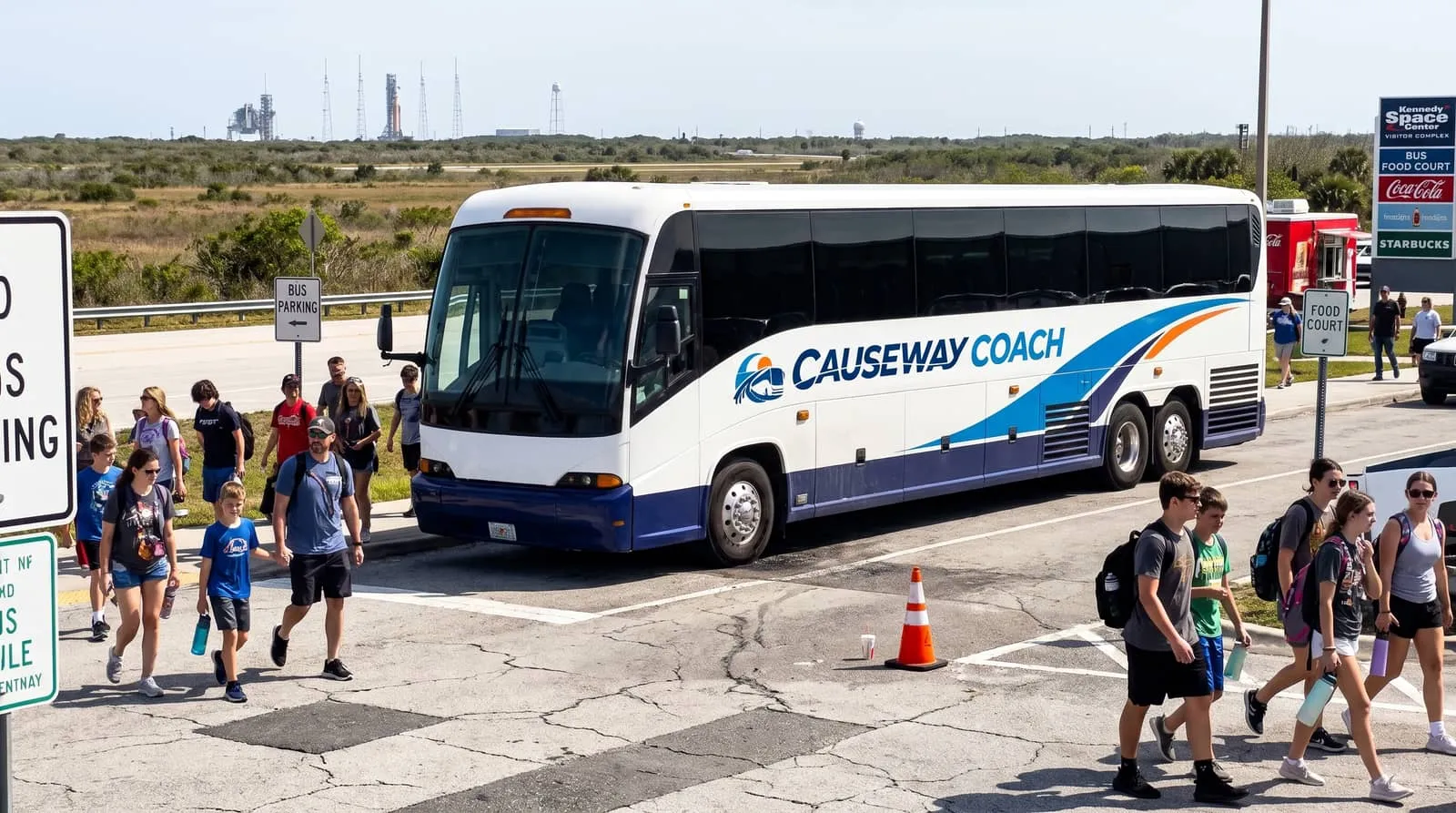 Causeway Coach motorcoach crossing a Space Coast causeway toward the visitor complex