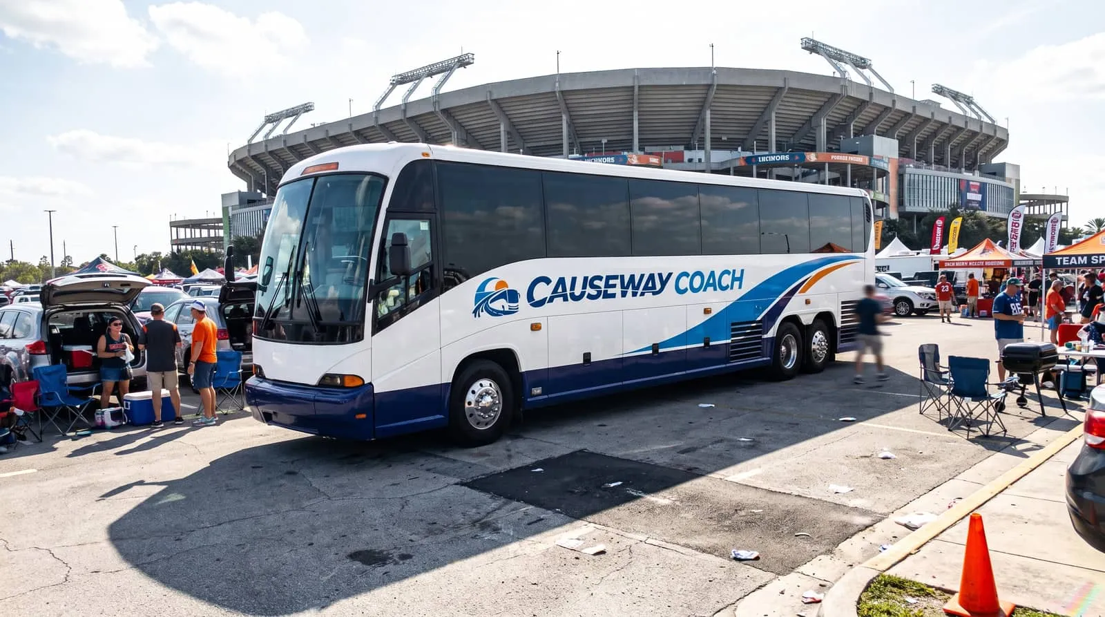 Causeway Coach motorcoach dropping a fan group outside a Florida stadium on game day